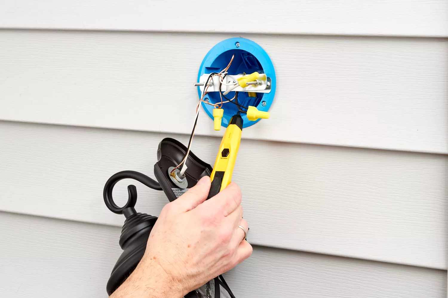 Using a voltage tester to make sure the power has been cut